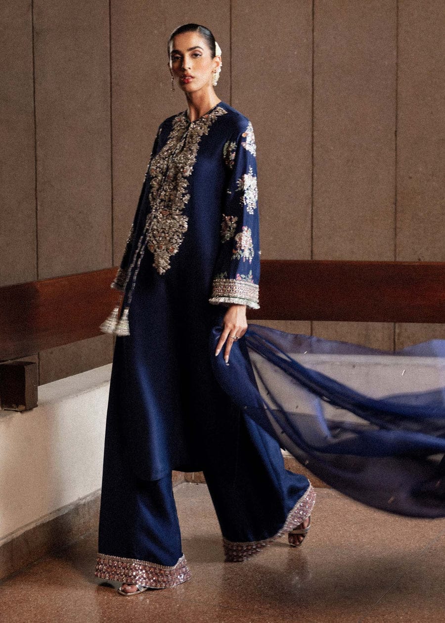 Classic Navy Blue Raw Silk Long Shirt with Silver Nakshi, Sequins & Multicolor Cut Dana Embellishments, Heavily Embellished Sleeves, Paired with Red Raw Silk Palazzo Pants and Organza Dupatta – Luxury 3-Piece Formal Ensemble